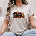 Sand Gildan Softstyle tee mockup with Halloween raccoons in skeleton, pumpkin and ghost costumes